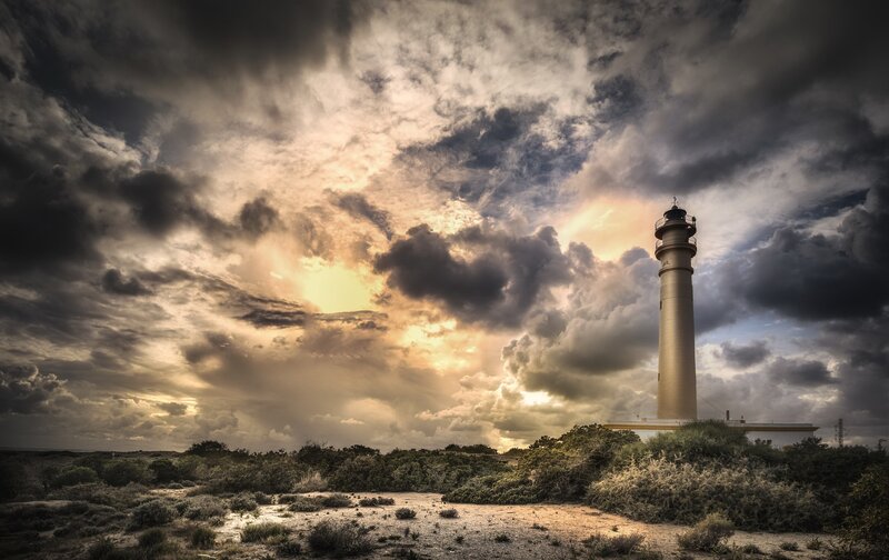 Lighthouse on a Hill — Gray, Dramatic, Sunset