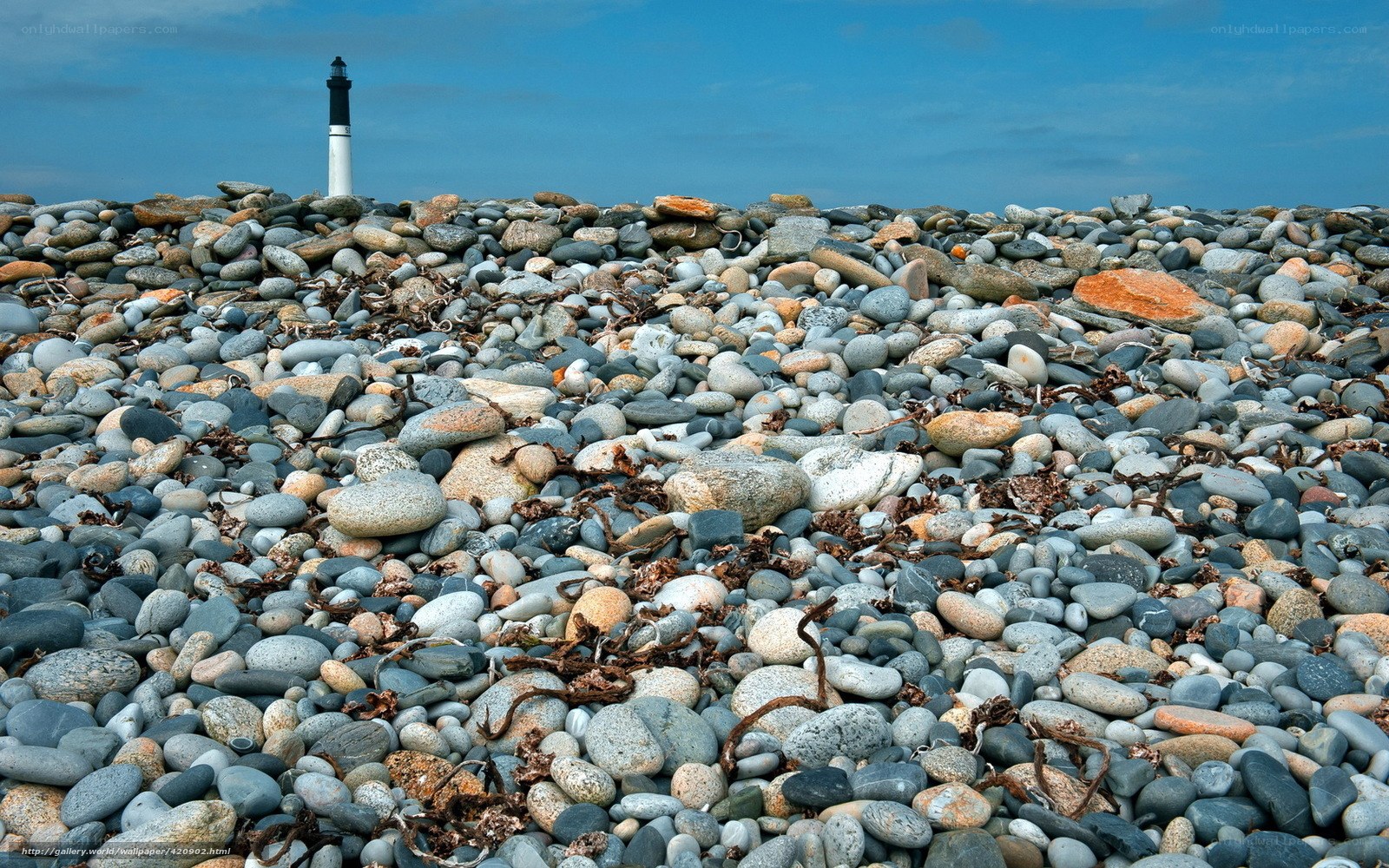 Lighthouse on a pebble beach