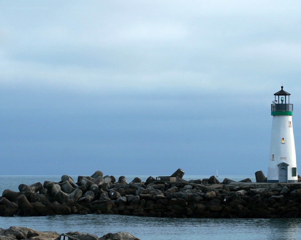 lighthouse on a rocky pier