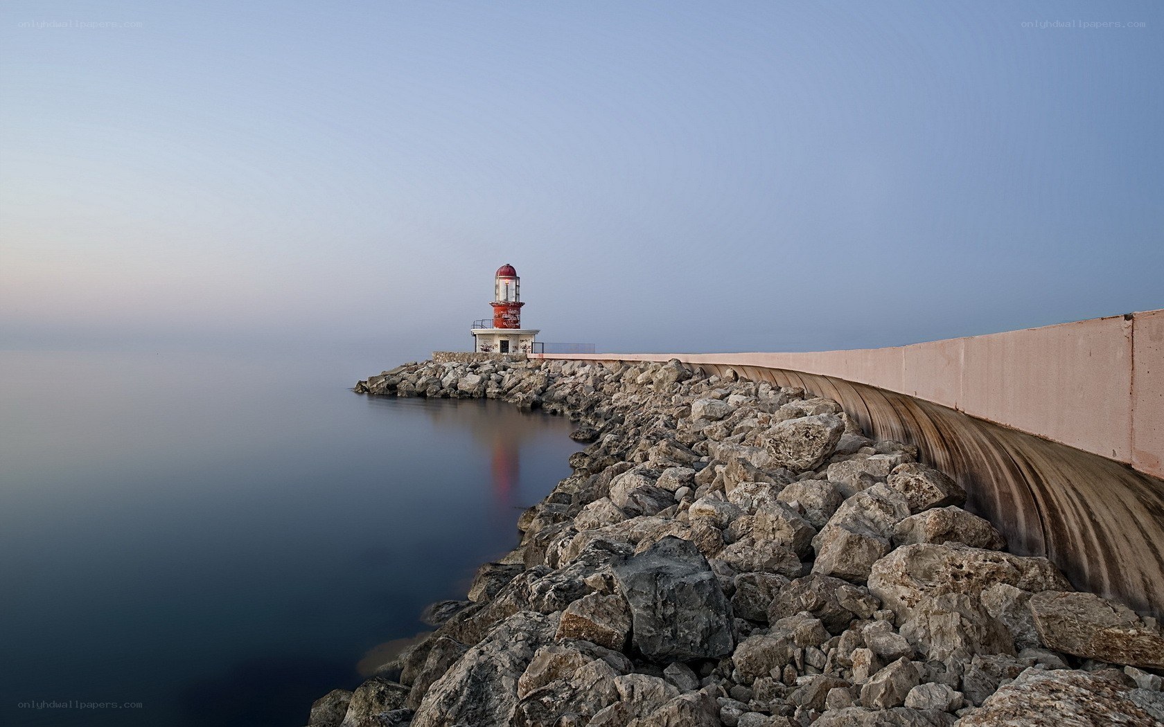 lighthouse on a rocky pier