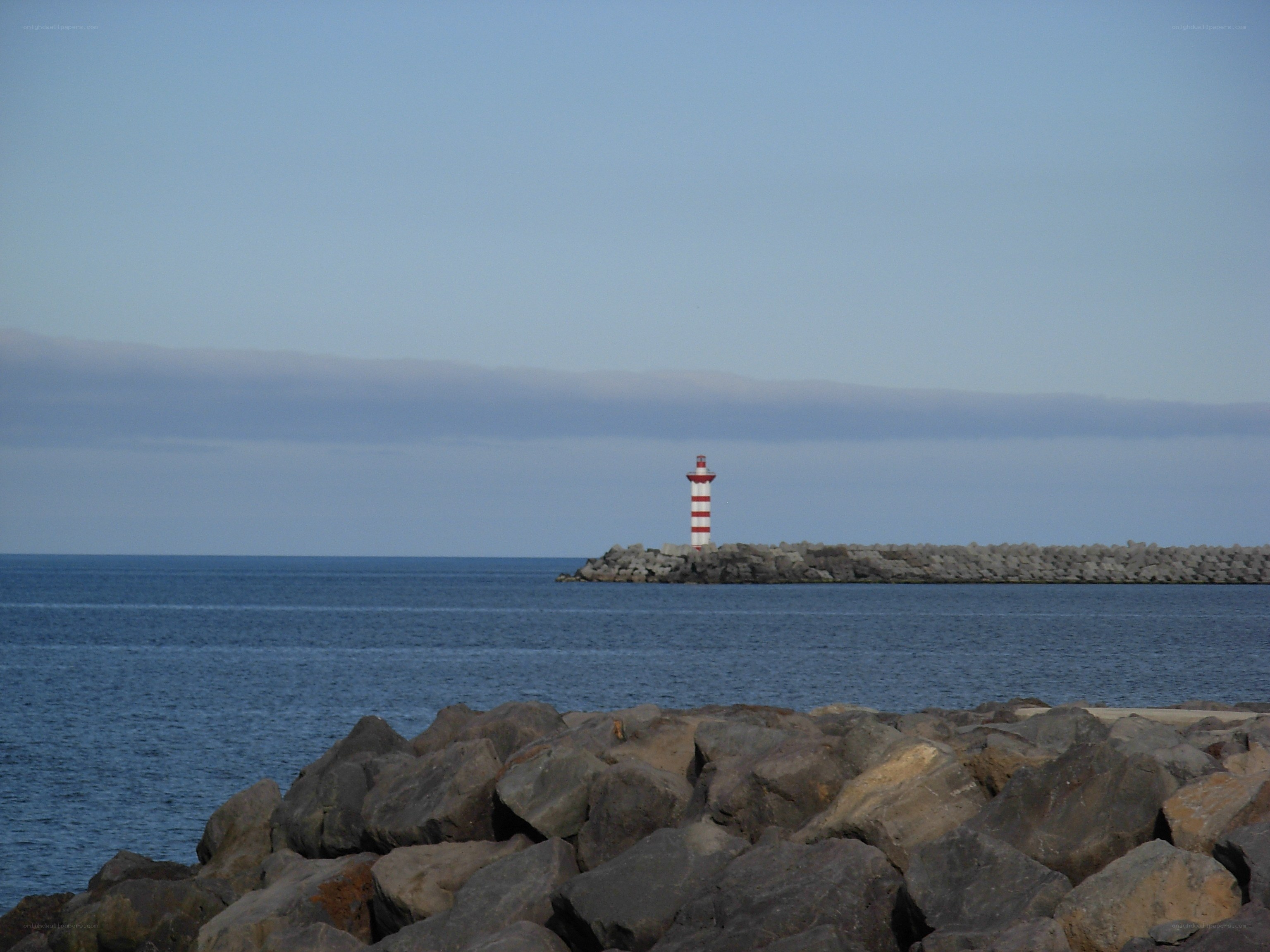 lighthouse on a rocky pier