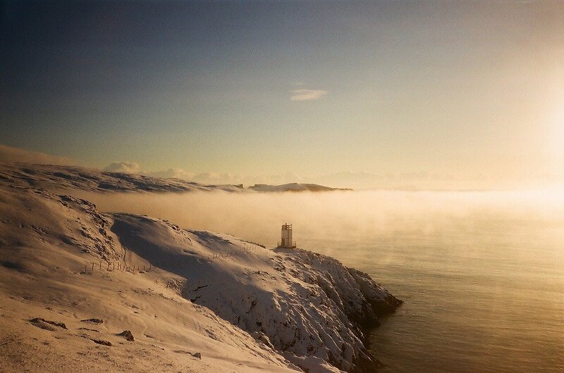 Lighthouse on a snowy cliff