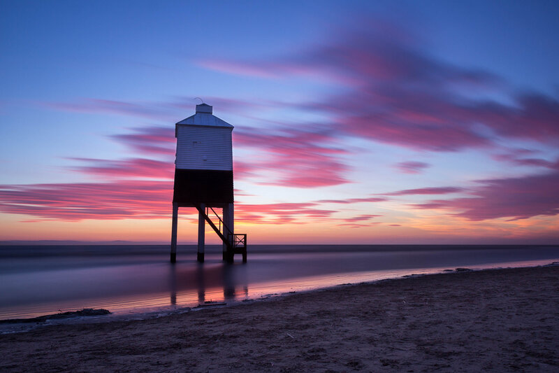 Lighthouse on Beach — Blue, Serene, Sunset, Photograph