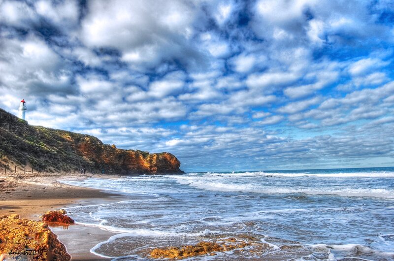 Lighthouse on Cliff — Blue, Dramatic, Afternoon, Photograph, Ocean, Beach
