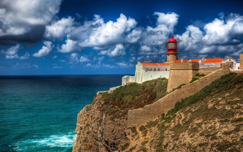 Lighthouse on Cliff — Blue, Dramatic, Afternoon, Photograph, Ocean, Clouds
