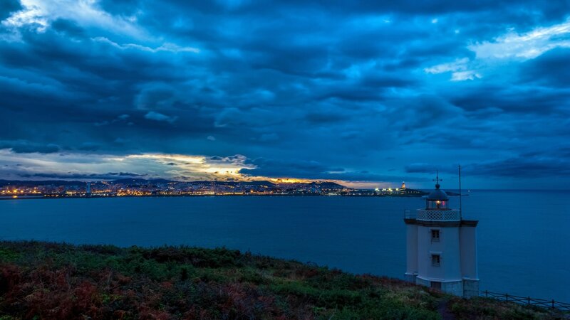 Lighthouse on Cliff — Blue, Dramatic, Night, Photograph, City Lights