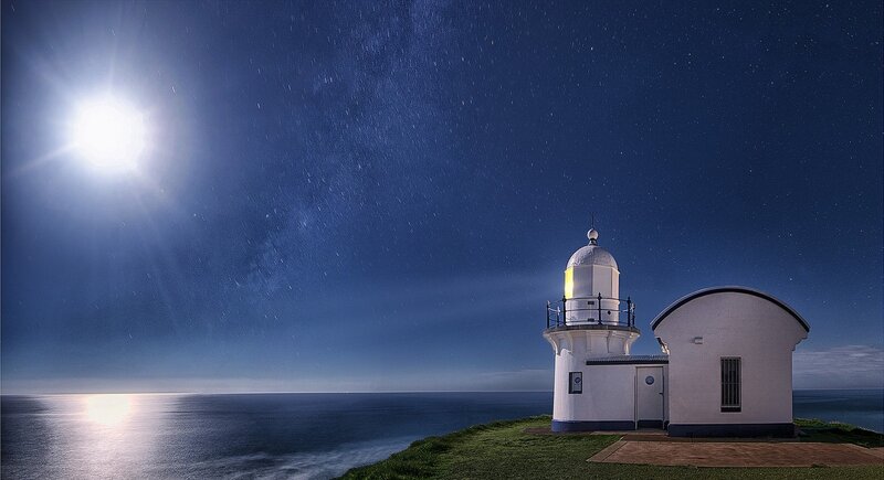 Lighthouse on Cliff — Blue, Serene, Night, Photograph, Moon, Ocean, Stars