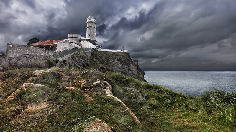 Lighthouse on Cliff — Gray, Dramatic, Photograph, Ocean, Clouds, Stone Wall