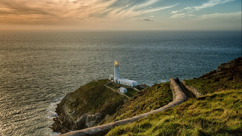 Lighthouse on Cliff — Green, Serene, Sunset, Photograph, Ocean