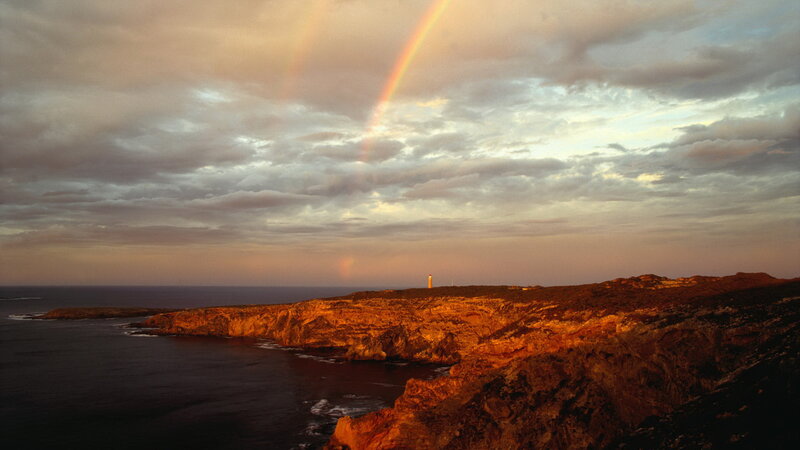 Lighthouse on Cliff — Orange, Dramatic, Sunset, Photograph, Rainbow