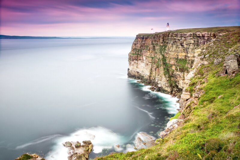 Lighthouse on Cliff — Purple, Serene, Sunset, Photograph, Ocean