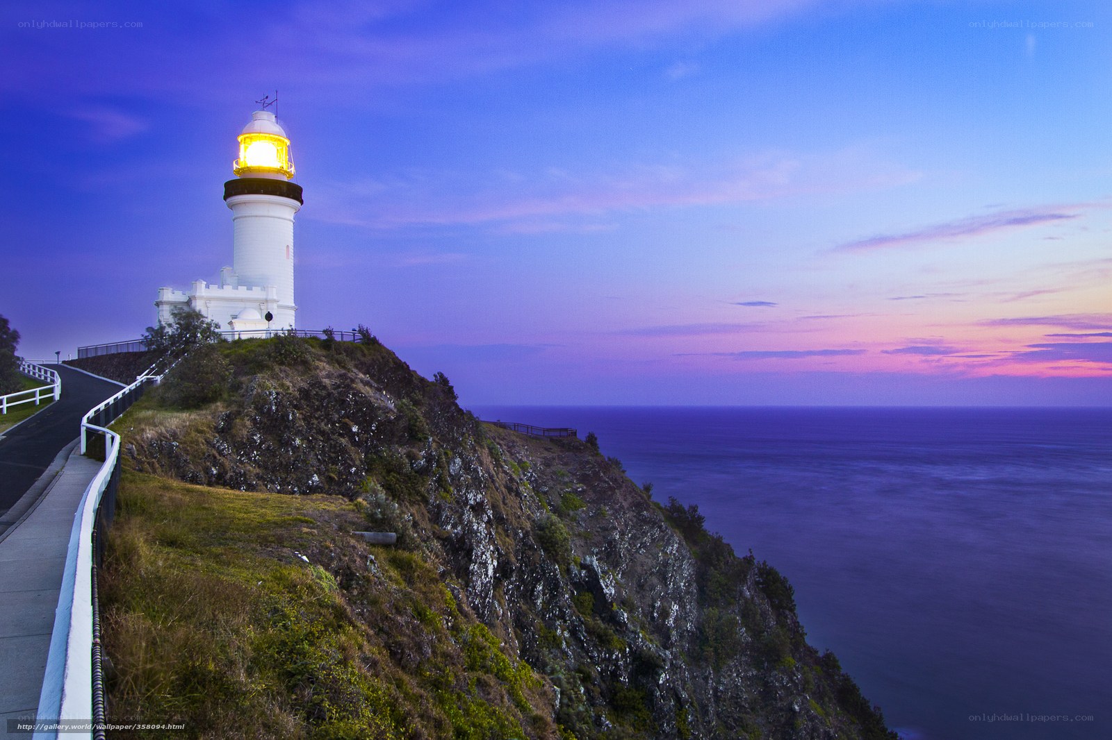Lighthouse on coastal cliff at dusk
