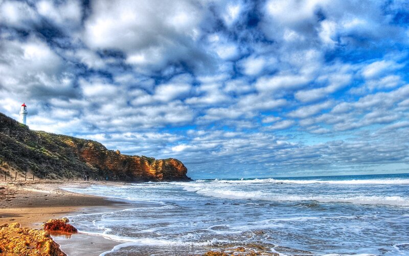 Lighthouse on Coastal Cliff — Blue, Dramatic, Afternoon, Photograph, Ocean, Beach