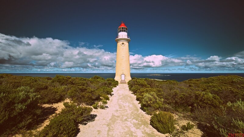 Lighthouse on Coastal Cliff — Blue, Dramatic, Afternoon, Photograph, Ocean, Sky