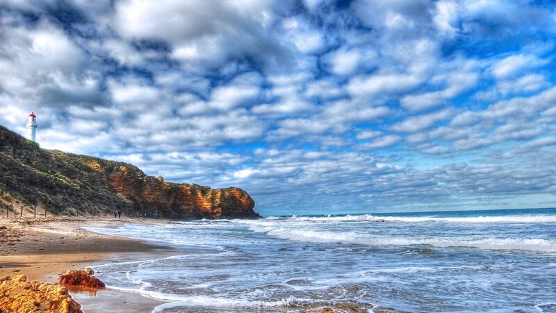 Lighthouse on Coastal Cliff — Blue, Dramatic, Afternoon, Photograph