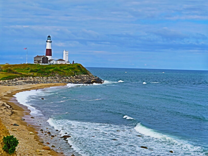 Lighthouse on Coastal Cliff — Blue, Serene, Afternoon, Photograph, Ocean, Beach, Flag