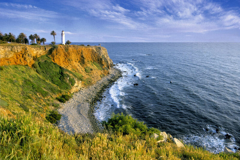 Lighthouse on Coastal Cliff — Blue, Serene, Afternoon, Photograph, Ocean, Palm Trees, Green, Brown