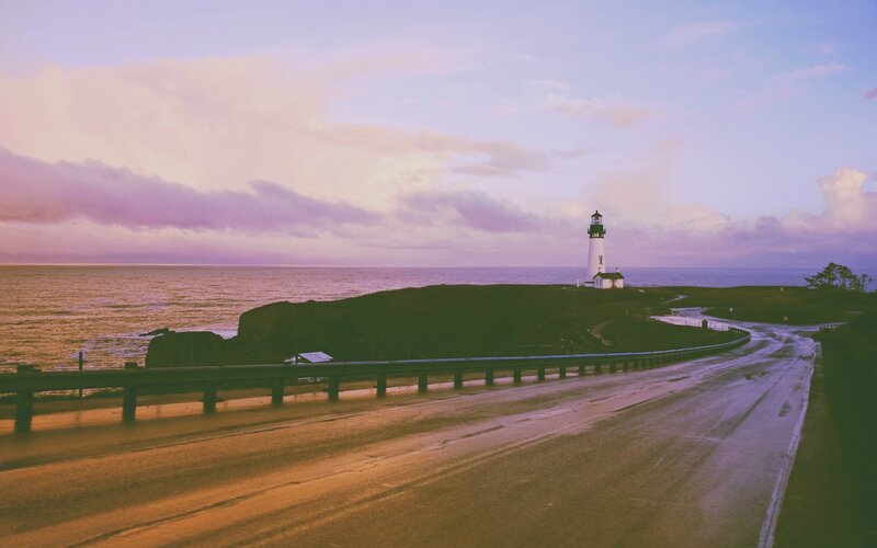Lighthouse on Coastal Cliff — Purple, Serene, Sunset, Photograph, Ocean, Road