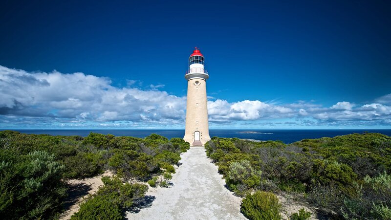 Lighthouse on Coastal Hill — Blue, Serene, Afternoon