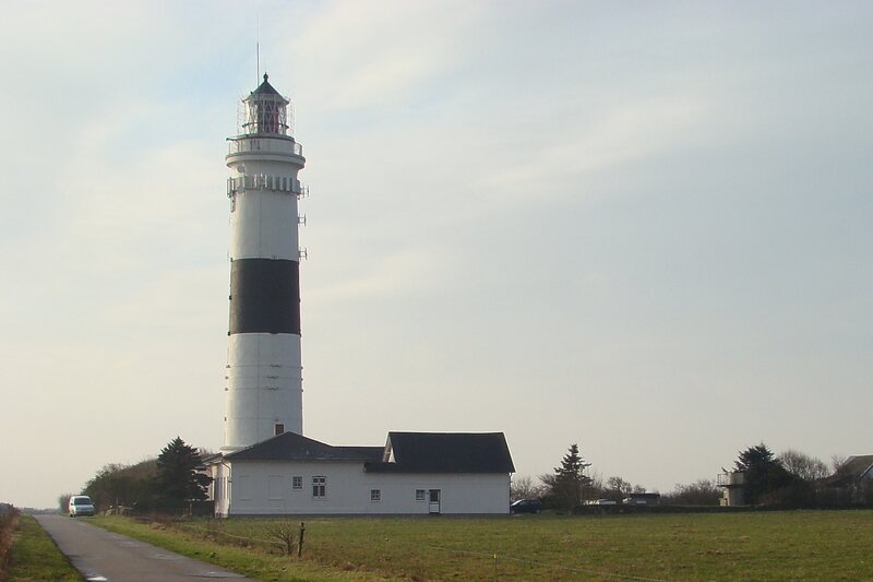 Lighthouse on Grassy Field