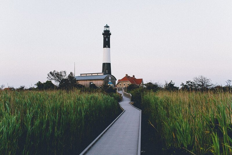 Lighthouse on Marshland — Green, Serene, Sunset, Photograph