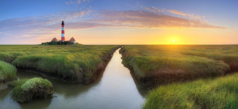 Lighthouse on Marshland — Green, Serene, Sunset