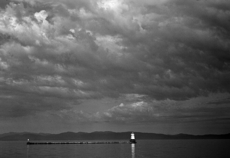 Lighthouse on Pier — Black, Dramatic, Photograph