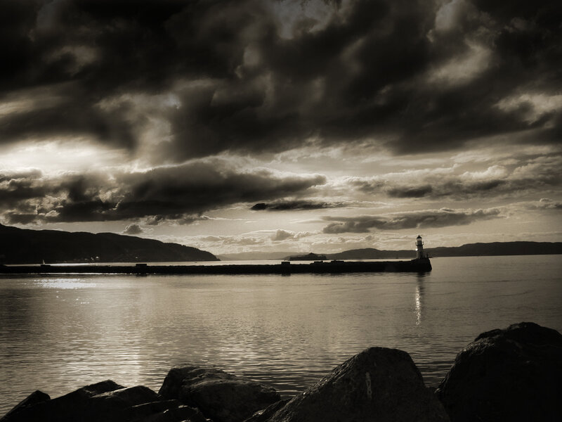 Lighthouse on Pier — Black, Dramatic, Sunset, Photograph, Clouds, Sea, Mountains