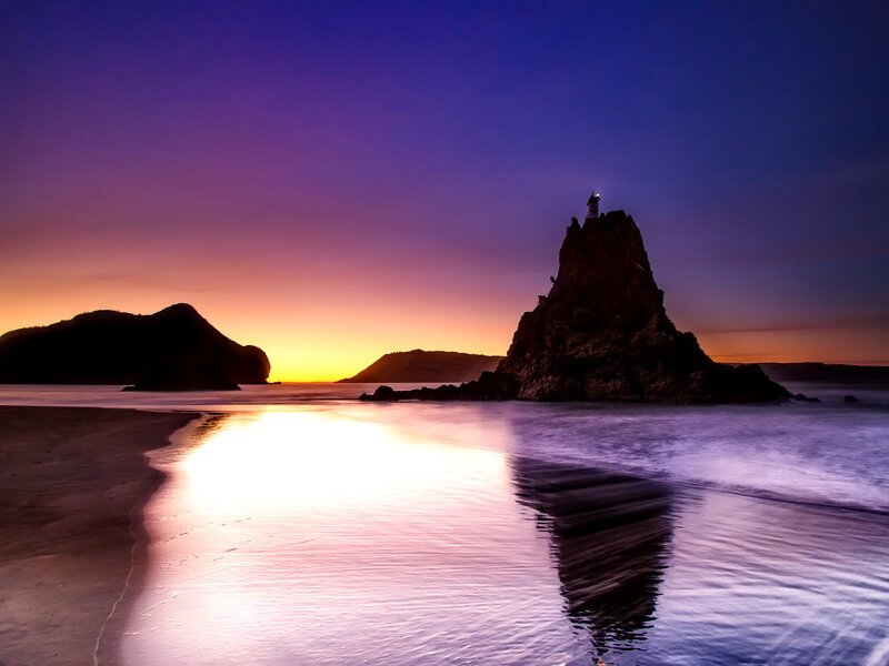 Lighthouse on Rock Formation — Purple