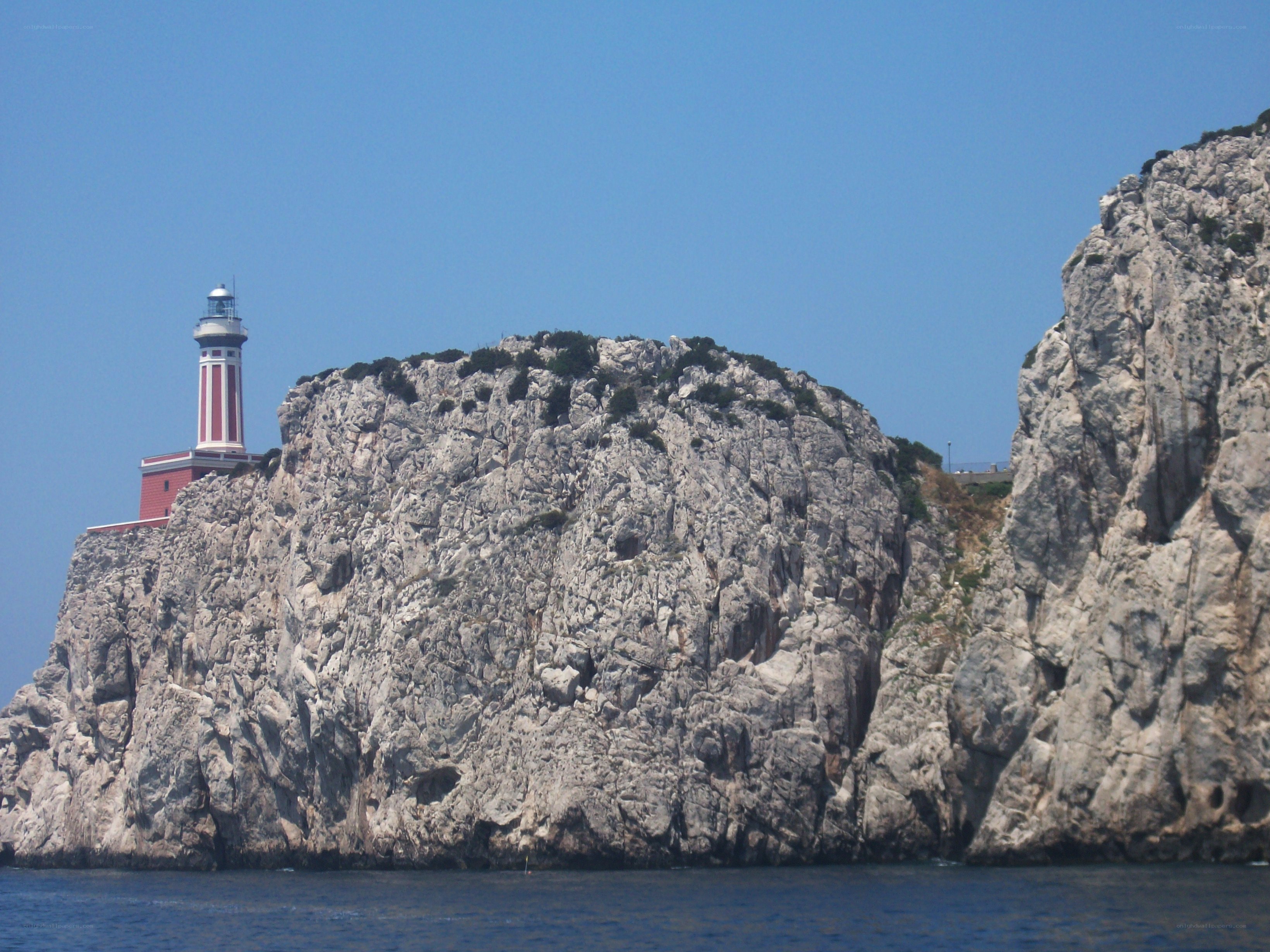 lighthouse on rocky cliff