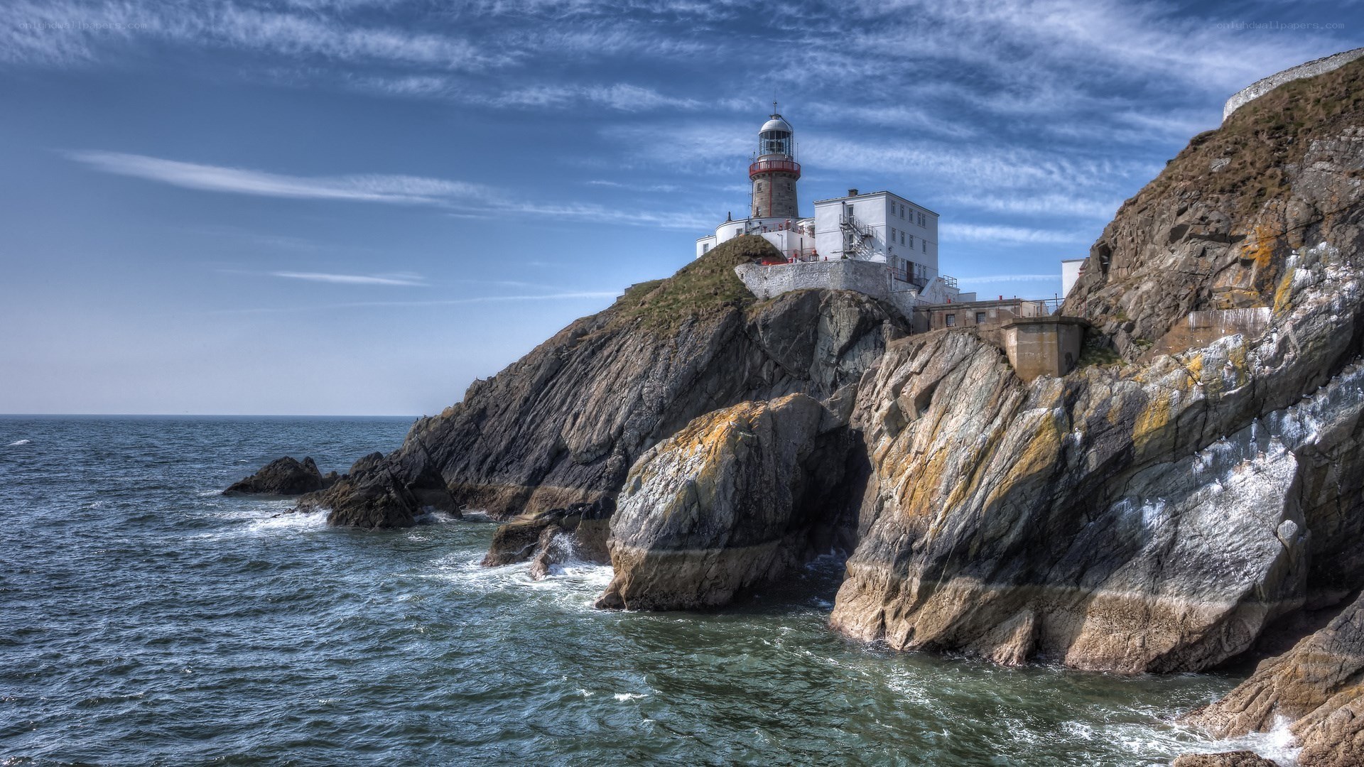 lighthouse on rocky cliff