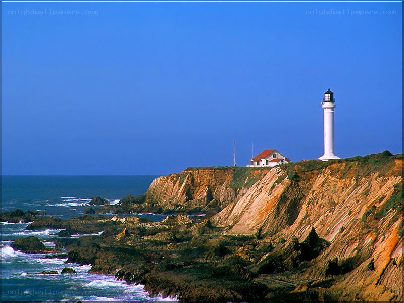 lighthouse on rocky cliff