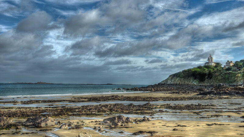 Lighthouse on Rocky Cliff — Blue, Dramatic, Afternoon, Photograph, Ocean, Beach
