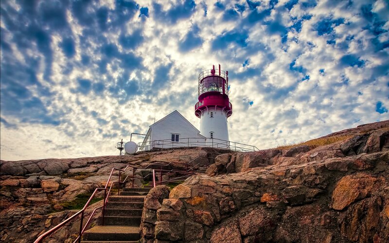 Lighthouse on Rocky Cliff — Blue, Dramatic, Afternoon, Photograph, Stairs