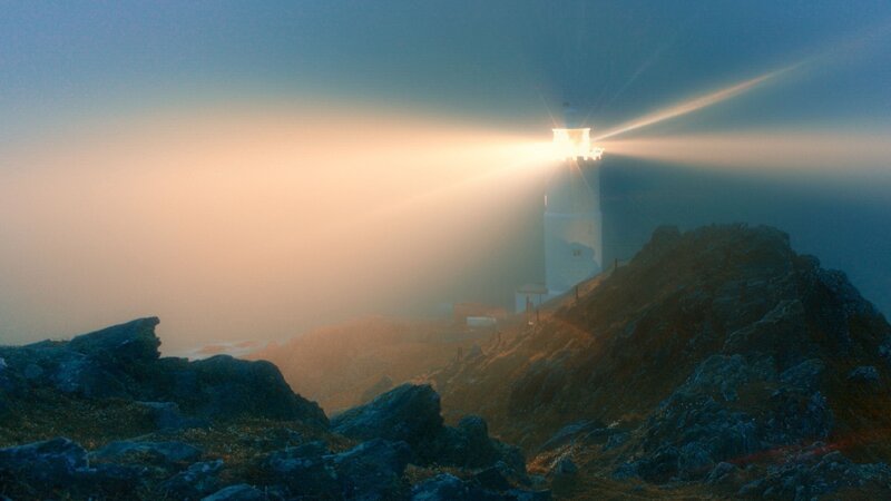 Lighthouse on Rocky Cliff — Blue, Dramatic, Sunset, Photograph, Fog, Rocks, Sea