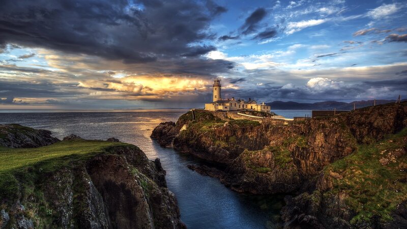 Lighthouse on Rocky Cliff — Blue, Dramatic, Sunset, Photograph, Ocean, Sky, Cliffs