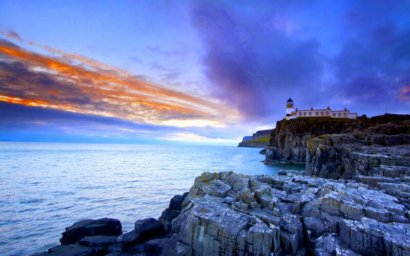 Lighthouse on Rocky Cliff — Blue, Dramatic, Sunset, Photograph, Ocean, Sky