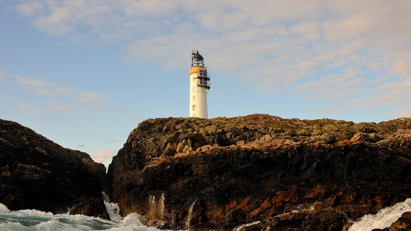 Lighthouse on Rocky Cliff — Blue, Dramatic, Sunset, Photograph, Ocean, Waves