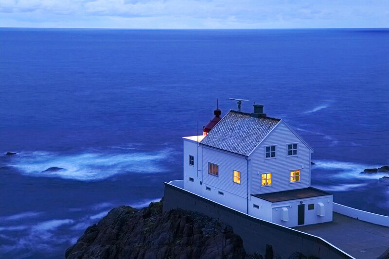 Lighthouse on Rocky Cliff — Blue, Serene, Night, Photograph, Ocean, Waves, Sky, White