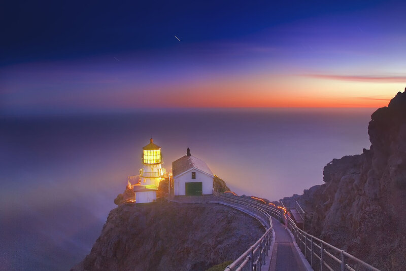 Lighthouse on Rocky Cliff — Blue, Serene, Sunset, Photograph, Ocean, Path