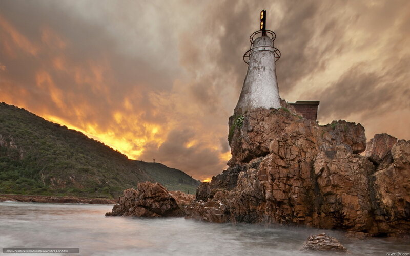 Lighthouse on Rocky Cliff — Orange, Dramatic, Sunset, Photograph, Sea