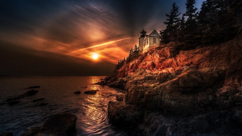Lighthouse on Rocky Cliff — Orange, Dramatic, Sunset, Photograph, Sun