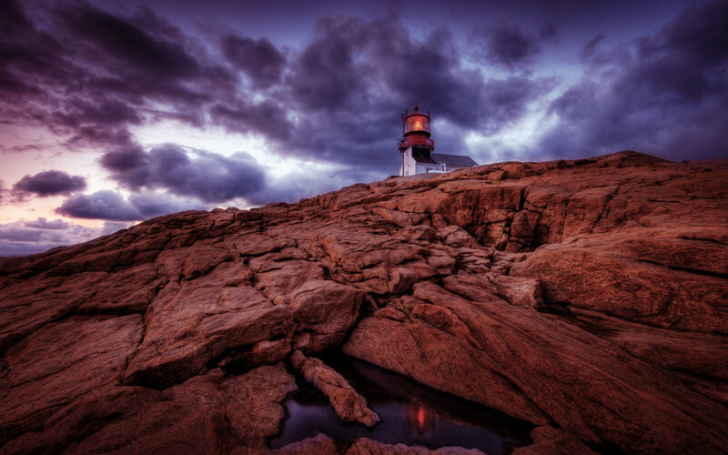 Lighthouse on Rocky Cliff — Purple, Dramatic, Sunset, Photograph, Clouds