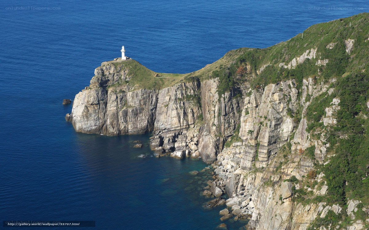 lighthouse on rocky cliff
