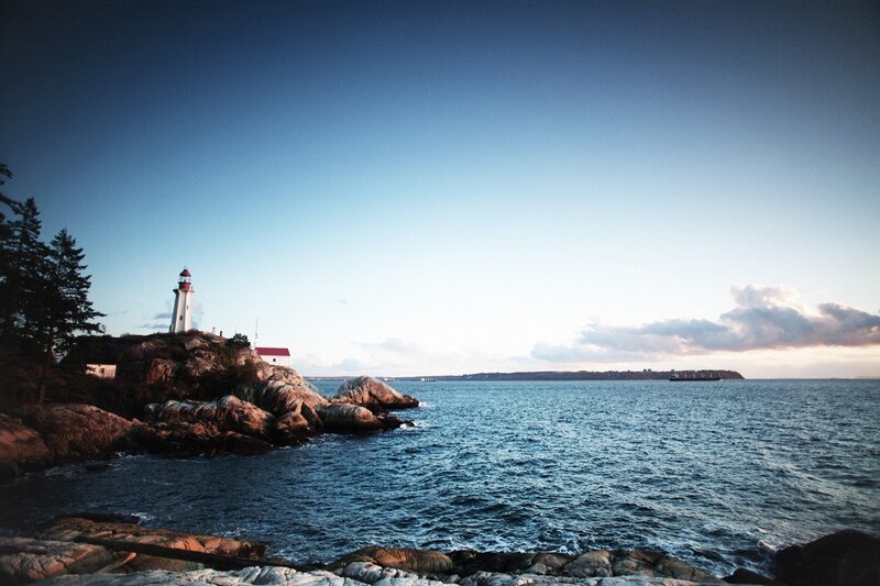 Lighthouse on rocky coast at dusk