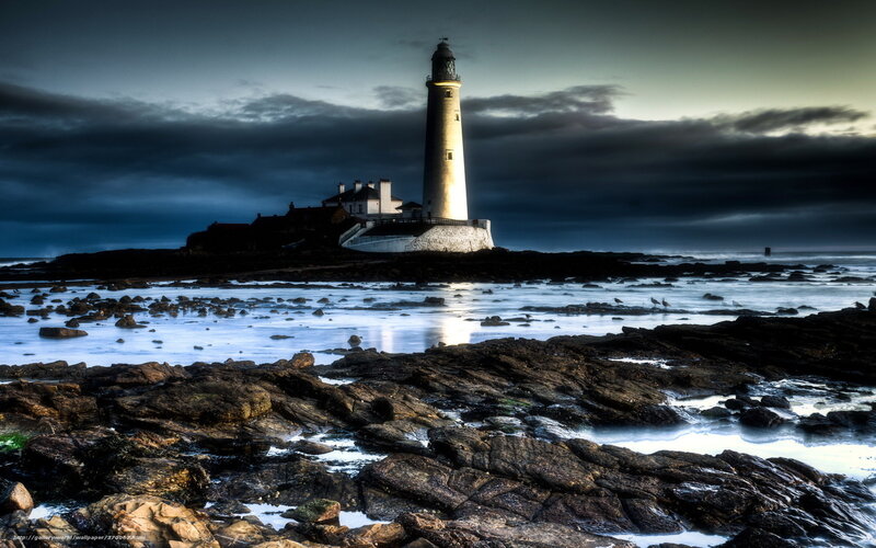 Lighthouse on rocky coast at dusk