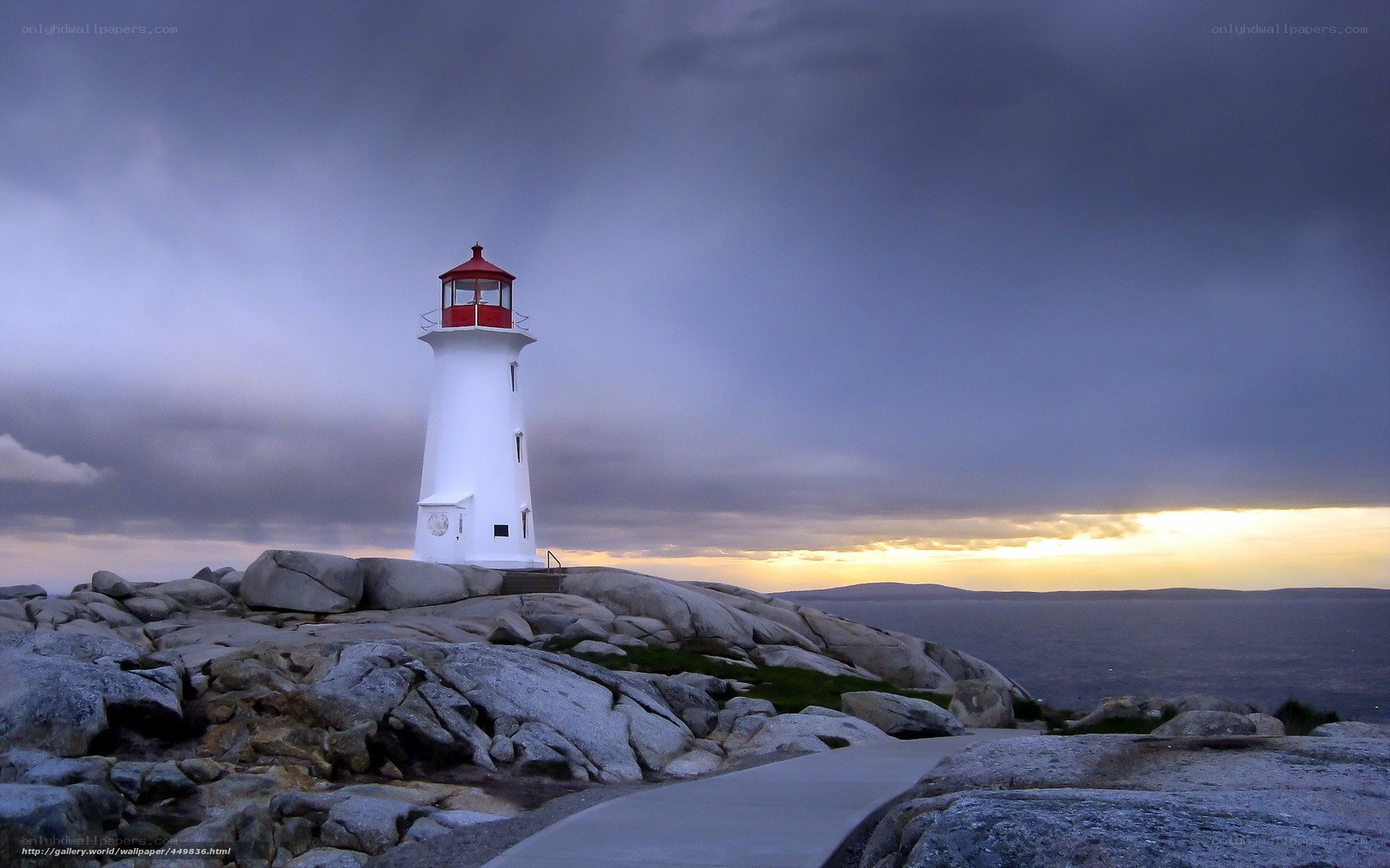 Lighthouse on rocky coast at dusk