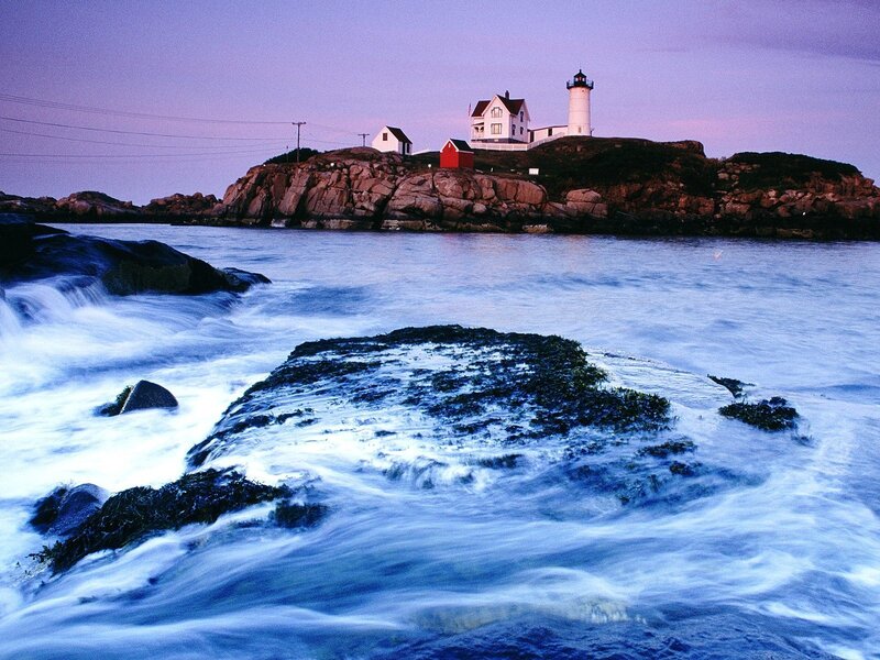 lighthouse on rocky coast at dusk