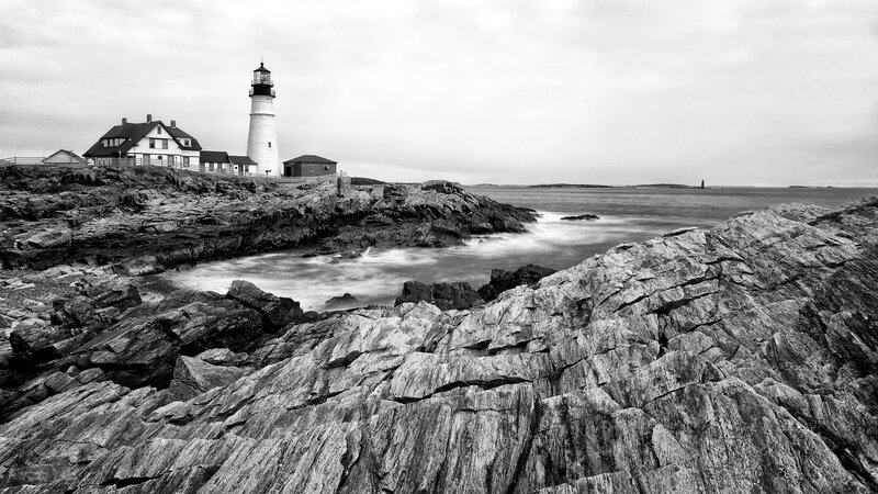 Lighthouse on Rocky Coast — Black, Dramatic, Photograph, Rocks