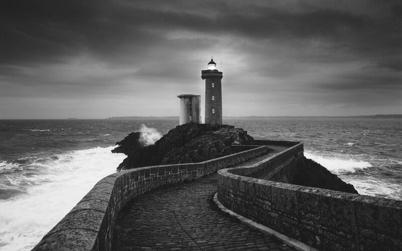 Lighthouse on Rocky Coast — Black, Dramatic, Photograph